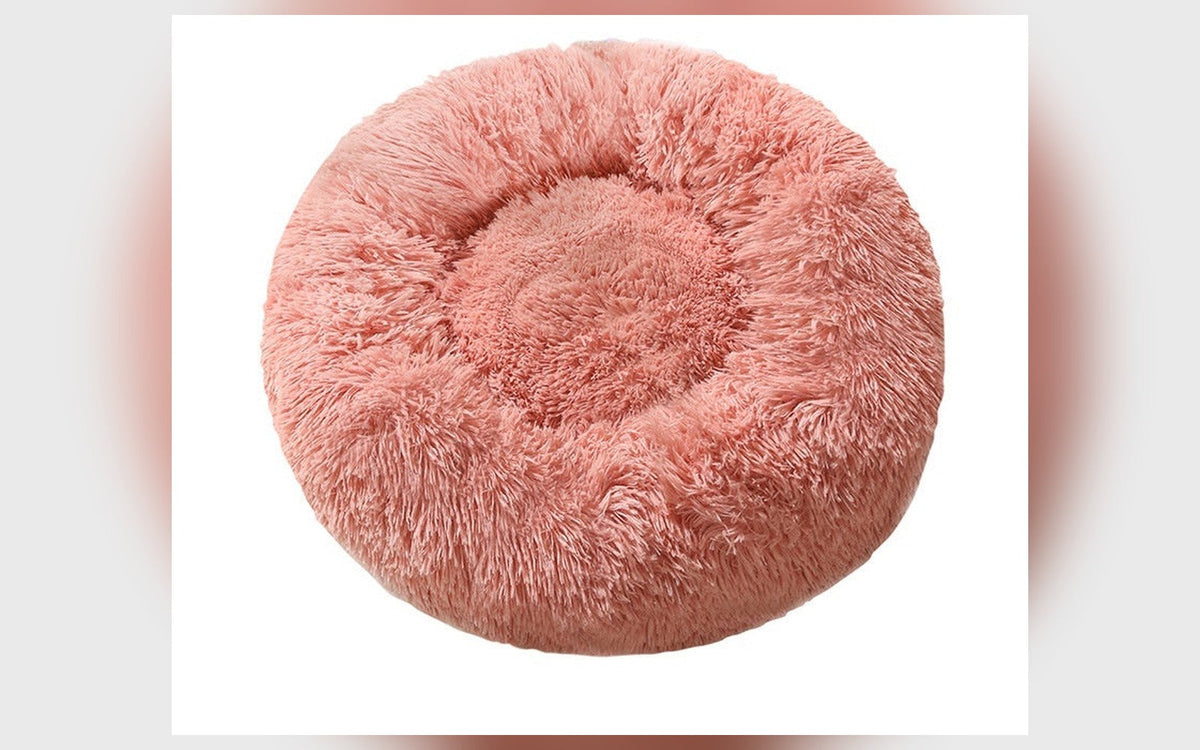 Round fluffy dog bed in pink